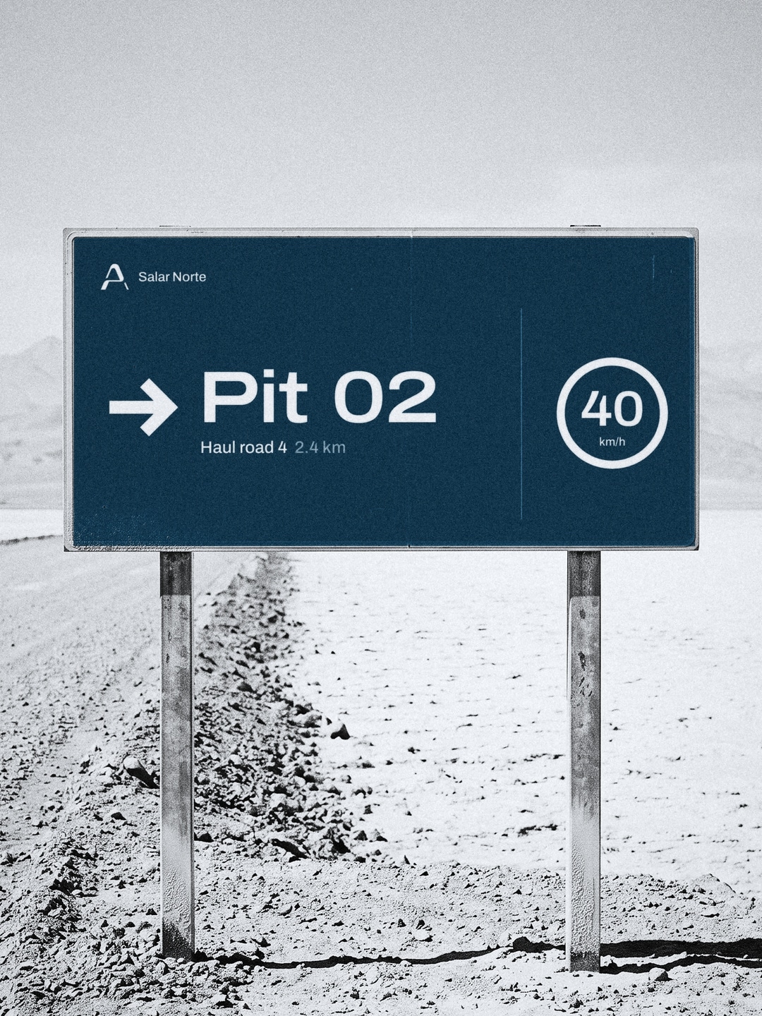 Das Schild Pit 02 neben einer Schotterstraße in der Wüste.