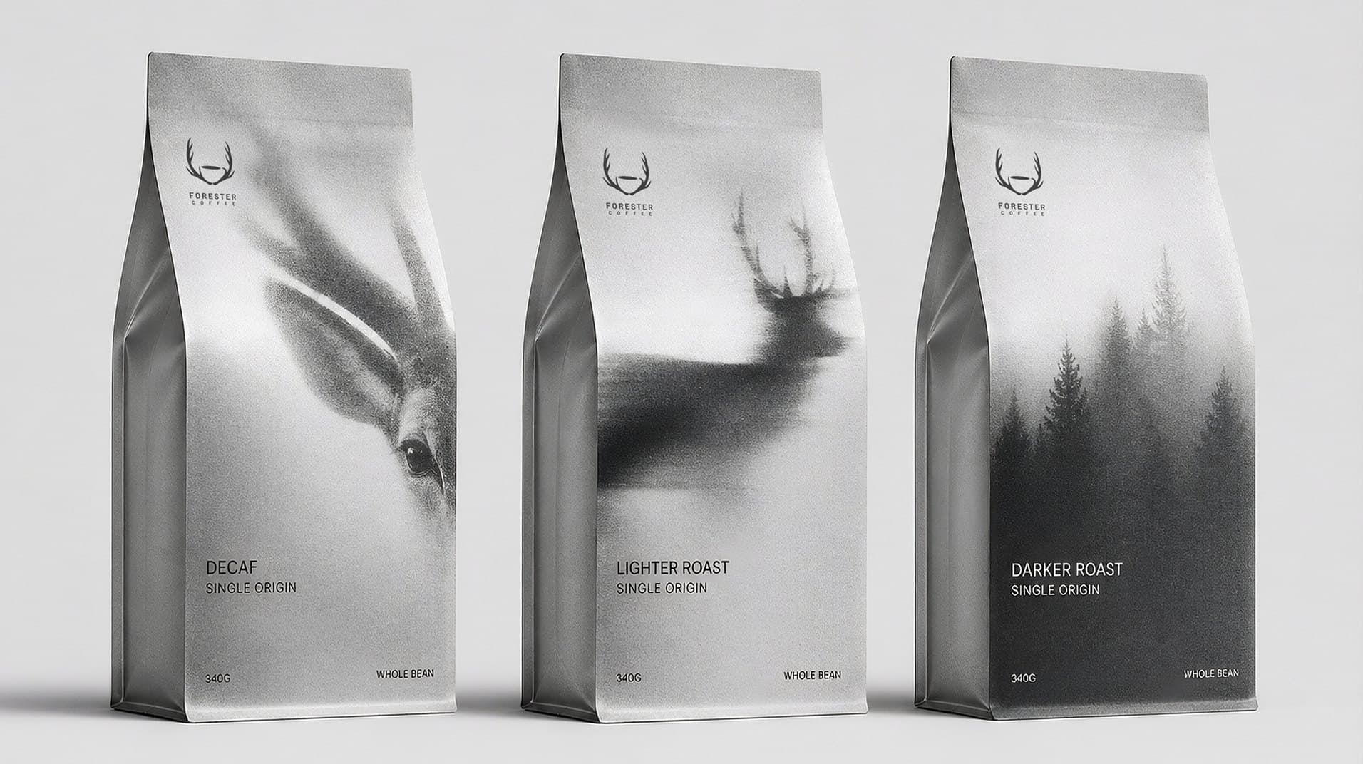 Three silver bags: Decaf with an animal close-up, Lighter Roast with a stag, Darker Roast with a forest