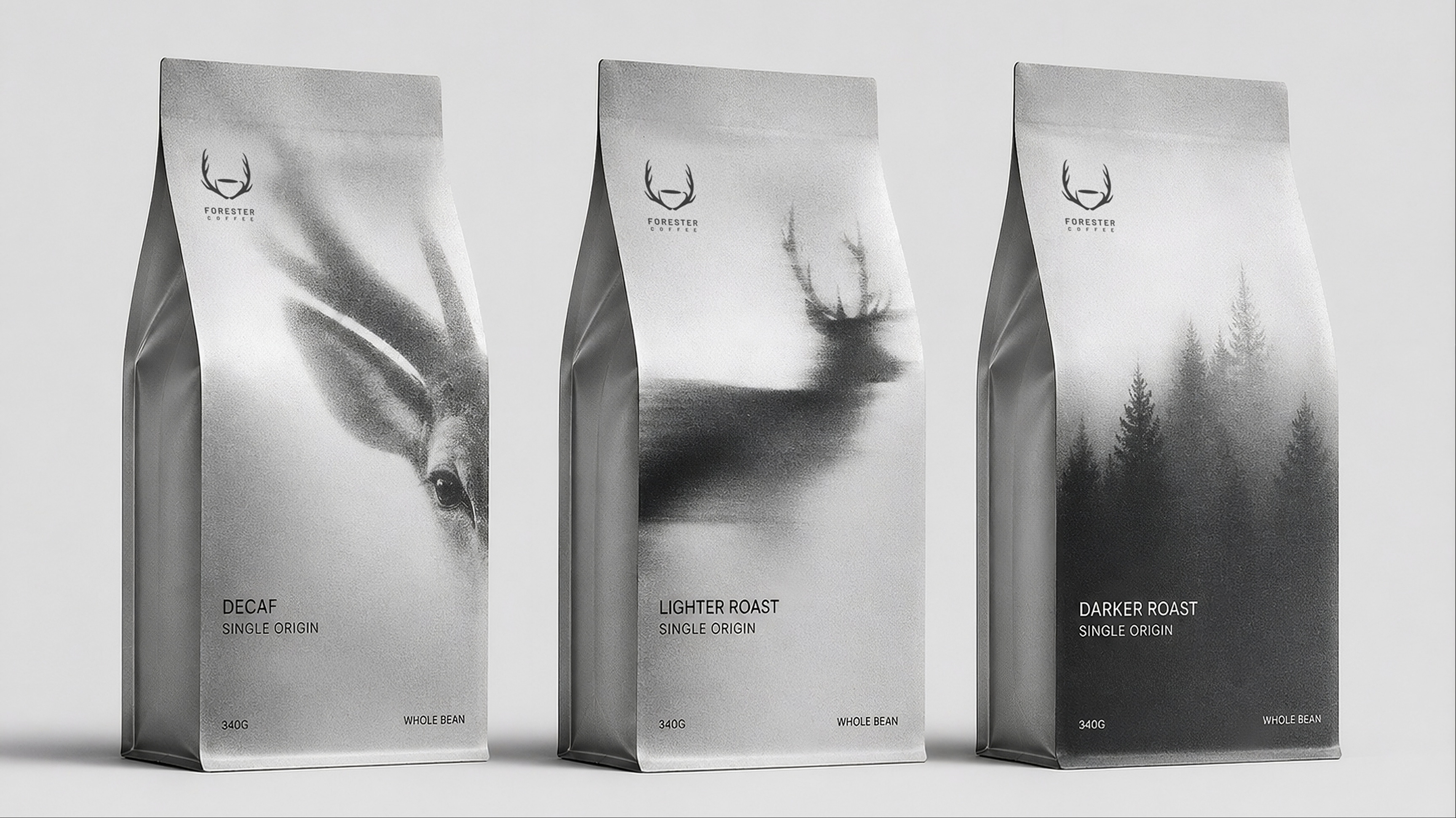 Three silver bags: Decaf with an animal close-up, Lighter Roast with a stag, Darker Roast with a forest