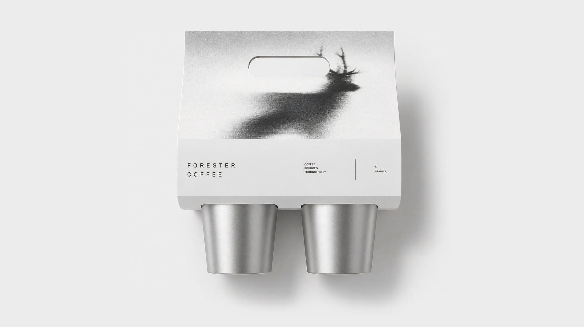 A printed cup carrier with the stag, holding two silver cups