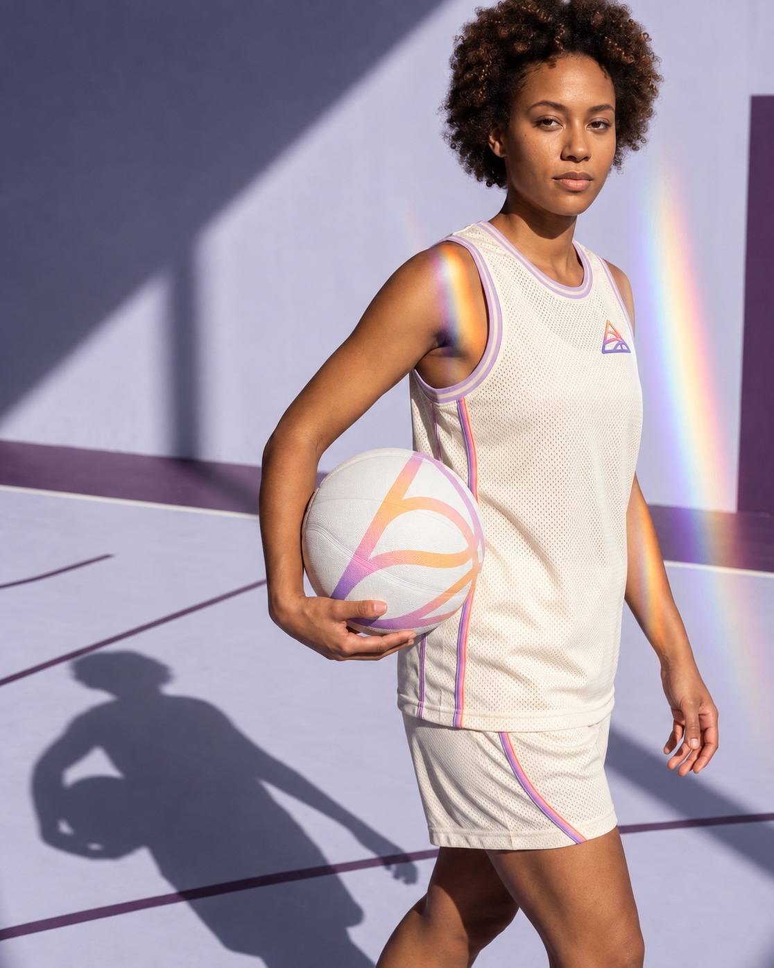A player in the cream kit, ball under her arm, on a lilac court