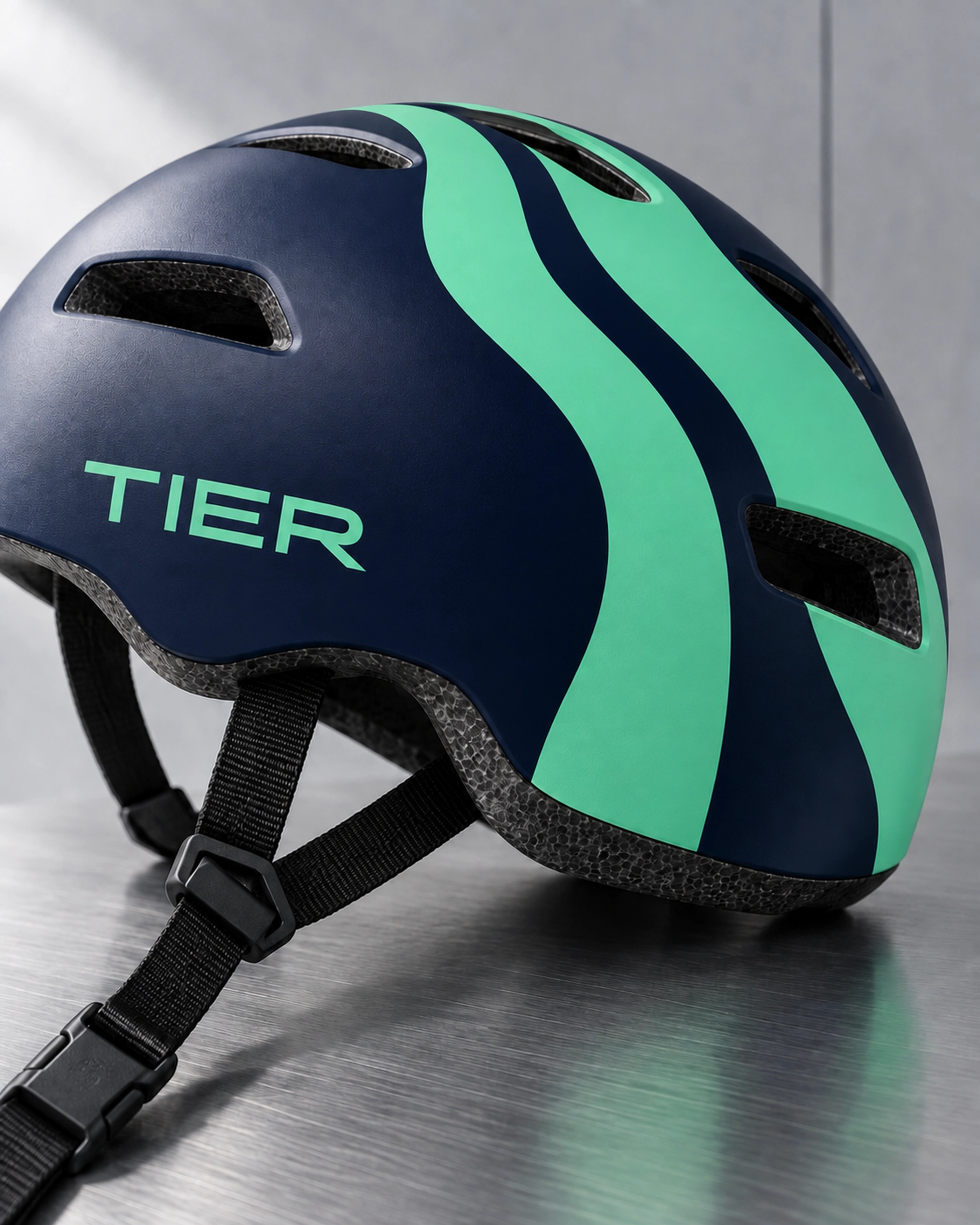 A navy helmet with mint ribbons and the wordmark.