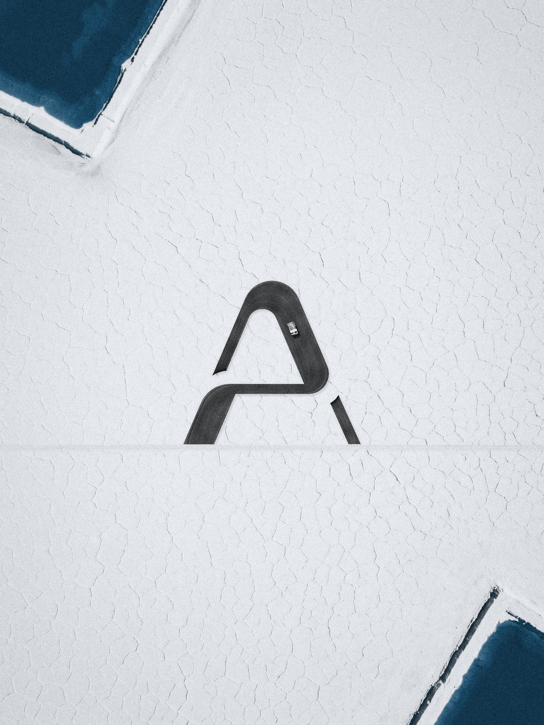 An A-shaped road seen from above on a salt flat.