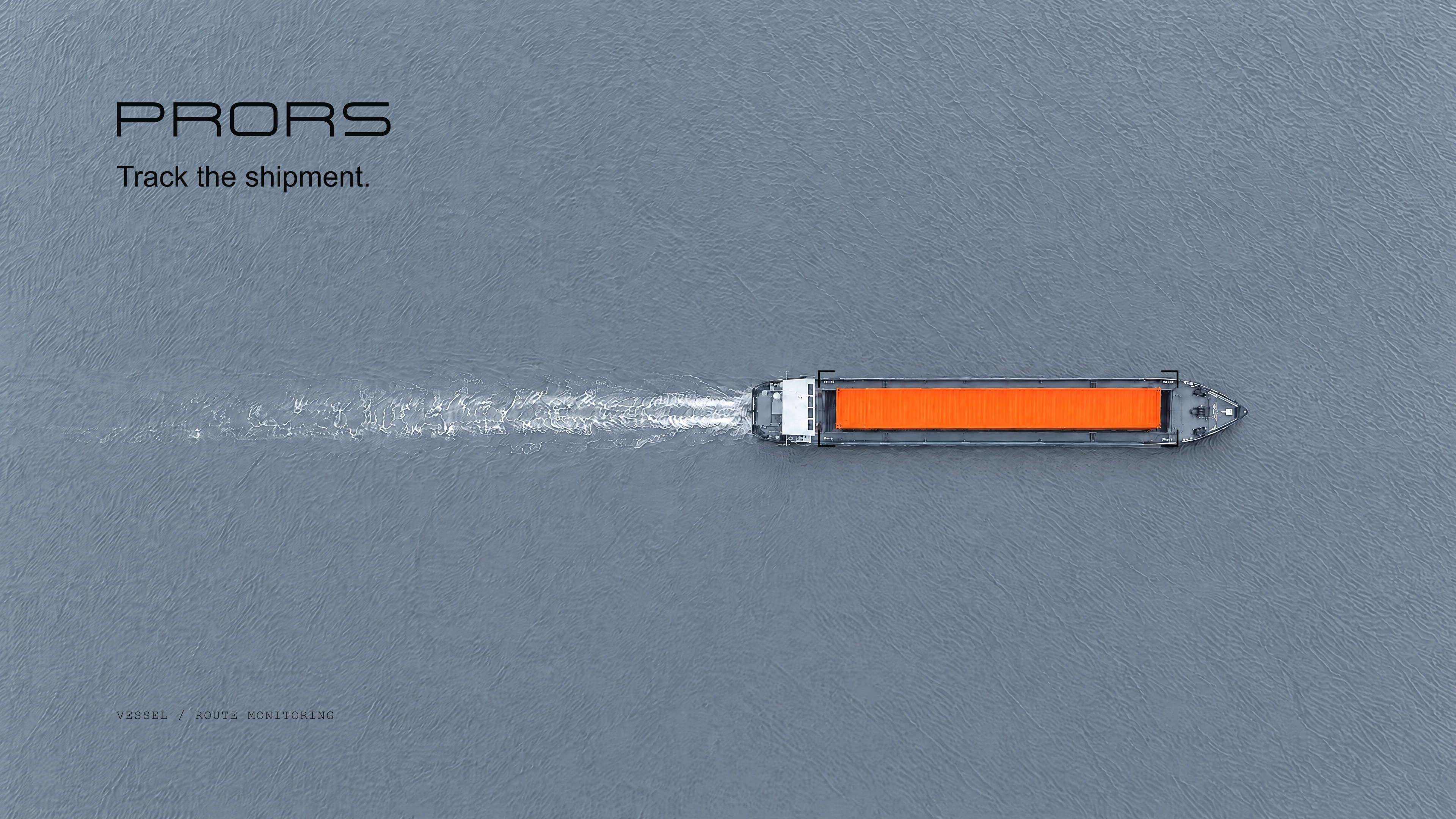 A single orange container on a ship on grey-blue water.